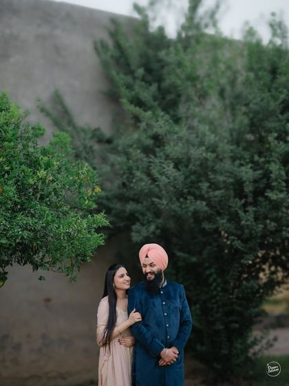 A classic couple portrait amidst the lush greenery of a historic location in Amritsar. The natural setting provides a soft and romantic backdrop for their pre-wedding photos.