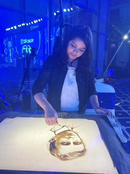 Another angle from a recent live show, focused on creating a detailed sand portrait. I am always grateful for the opportunity to share my art.