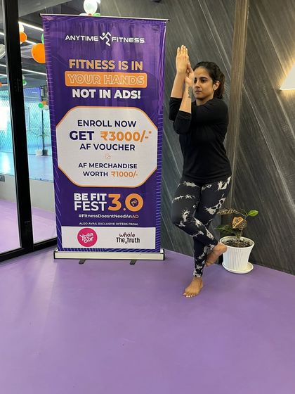 This member holds a steady and graceful Eagle Pose, reflecting the benefits of our guided yoga sessions.