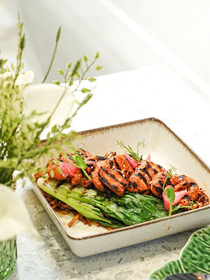 Our Korean BBQ chicken is grilled to perfection and served on a bed of greens. The char marks add a smoky flavor that pairs beautifully with the sweet and savory marinade.