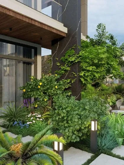 A ground-level view of the garden, where carefully placed lighting and a variety of plant species create a rich, textured landscape that can be enjoyed day and night.
