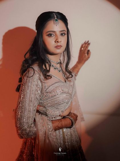 A portrait of the bride looking thoughtful, with dramatic spotlighting creating strong shadows.