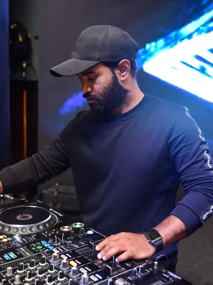 In the zone, focused on the mix. A huge part of my job is reading the crowd and selecting the perfect track to play next, keeping the energy flowing all night long.