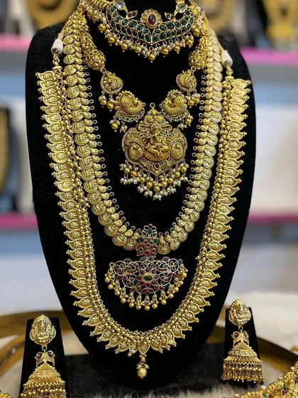 This set combines a traditional Kasu Malai (coin necklace) with a more intricate temple-style haram for a unique layered effect.