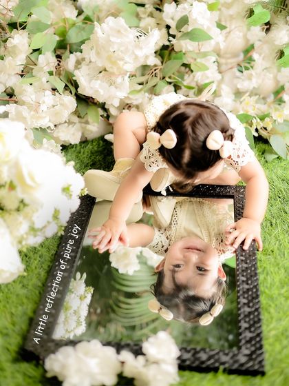 A unique overhead shot showing the baby's reflection in a mirror. I love experimenting with different angles to create visually interesting photographs.