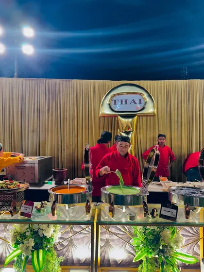 My chefs at the Thai station, busy serving guests from a selection of curries and other traditional Thai dishes.