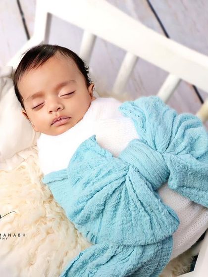A close-up of the baby's face, looking calm and content.