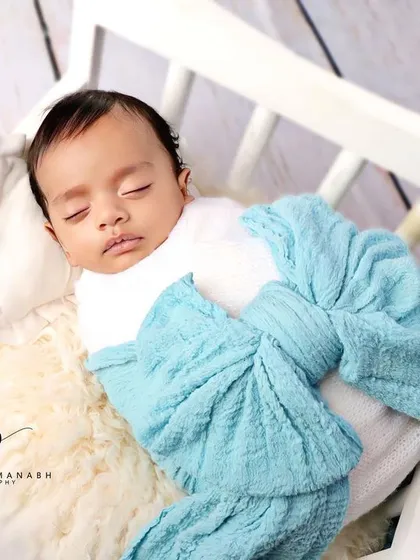 A close-up of the baby's face, looking calm and content.