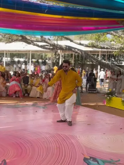 Here I am, taking center stage to get the party started. As your hype man, I love jumping in with a solo performance to get everyone in the mood for a full-power sangeet dance session.
