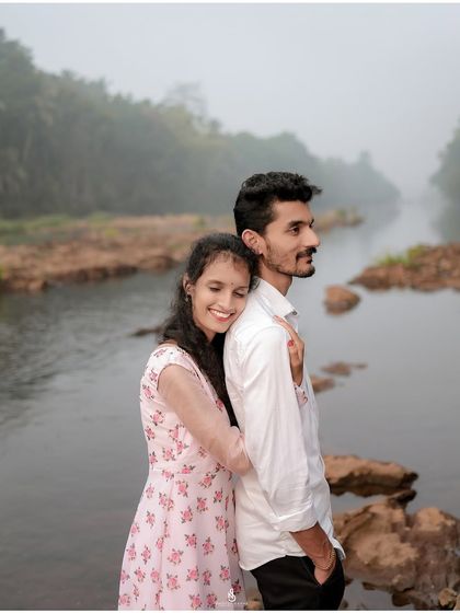 A warm hug from behind with the river flowing in the background. The misty weather adds a touch of magic to this riverside pre-wedding shoot.