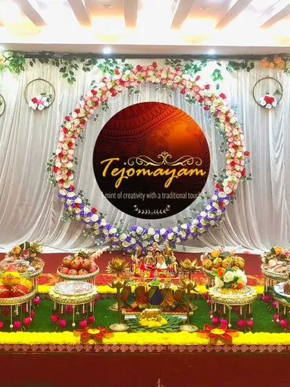 A traditional plate decoration for an Ear Piercing Ceremony, with a floral ring backdrop and hanging hoops.