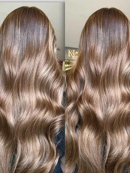 This side-by-side comparison shows the beautiful, cool-toned bronze lowlights in long hair. The color has a gingerbread biscuit feel, perfect for adding a touch of warmth to a cool palette.