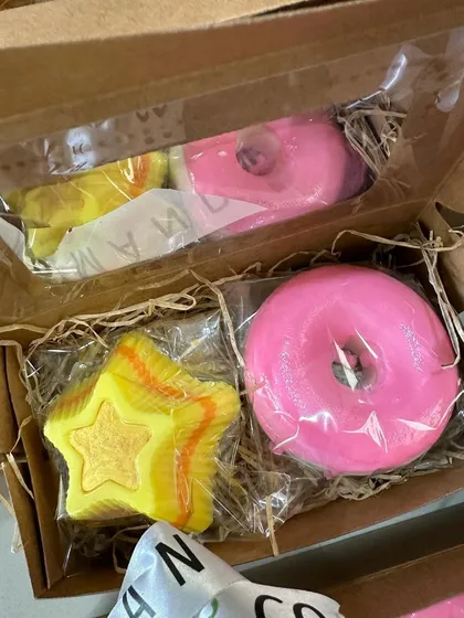 A closer look inside the donut and star soap box, showing the vibrant colors and fun shapes.