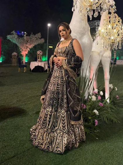 A full-length view of this magnificent black and gold lehenga. It's an outfit that commands attention and is perfect for a grand wedding night.