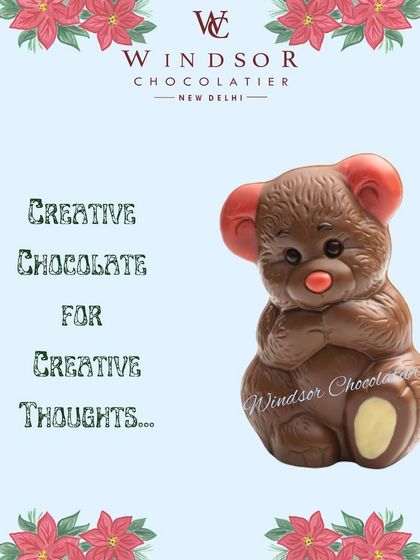 A sweet, shy-looking teddy bear made of milk chocolate with red ears and nose, perfect as a creative gift.