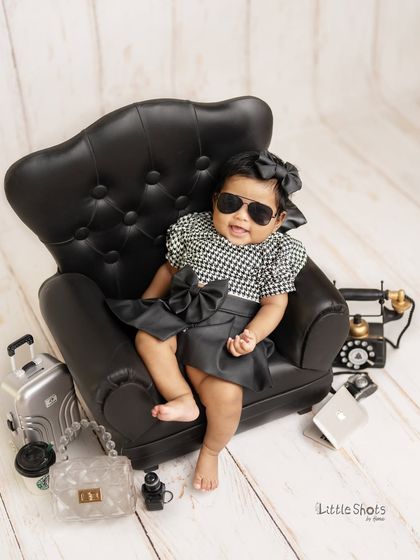 This little boss lady is ready for her close-up. The sunglasses and confident smile make this a fun and stylish portrait.