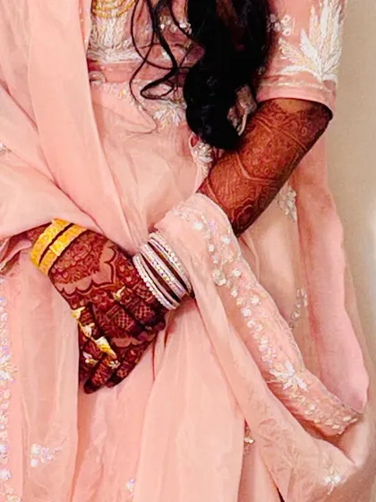 A candid shot of my bride showing off her beautiful henna stain. The color looks so rich against her elegant pink outfit.