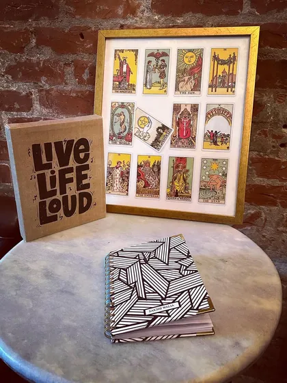 Busy manifesting. A vision board is one of the best tools to help you achieve your goals. This is a close up of the materials and the beautiful tarot card frame that inspires our vision board parties.