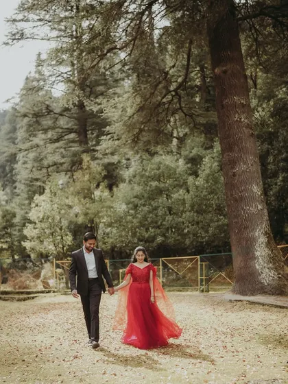 A beautiful shot of the couple walking hand-in-hand through a park in Dalhousie during their post-wedding shoot.