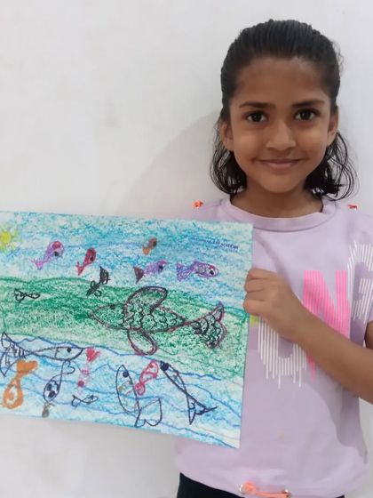 Krishika, a 1st standard student, drew this imaginative 'flying fish' scene with oil pastels. It's a wonderful example of how we encourage children to be creative and have fun with their art.