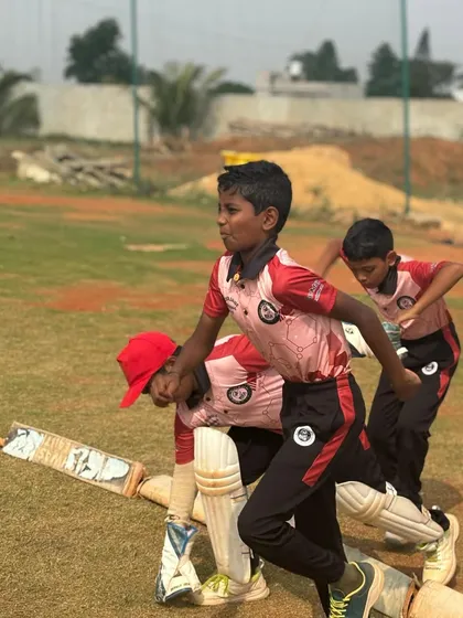 Young batters practice running between the wickets during a league match. We train our players on all aspects of the game, including smart and aggressive running.