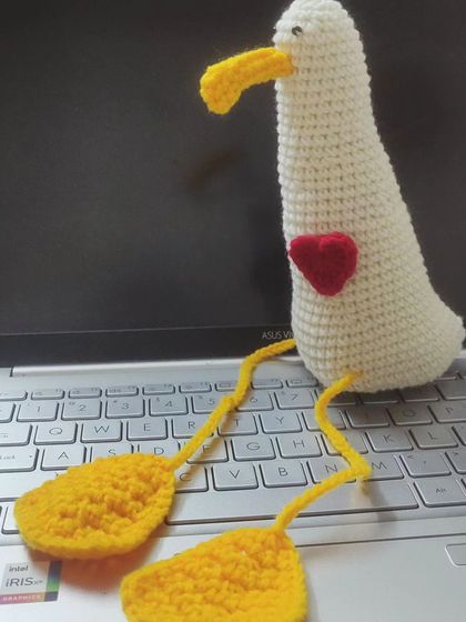 A sweet duck amigurumi with a little red heart, sitting on my laptop as a work buddy. Sometimes the simplest creations bring the most joy.