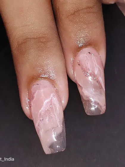 A close-up of the delicate marble and glitter details.