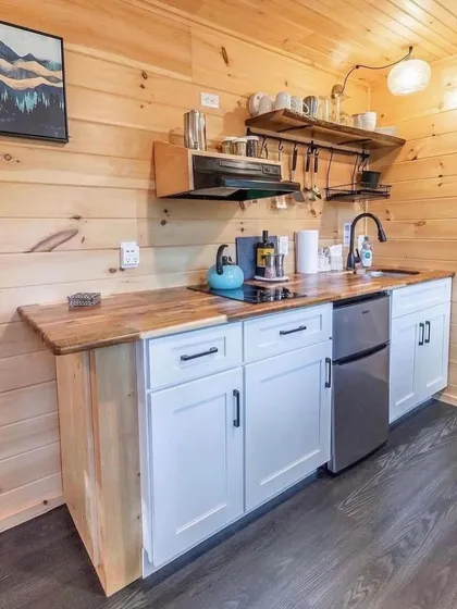 A compact yet fully functional kitchenette inside one of our container homes. It includes a mini-fridge, induction cooktop, and ample storage, proving that small spaces can still be highly practical.