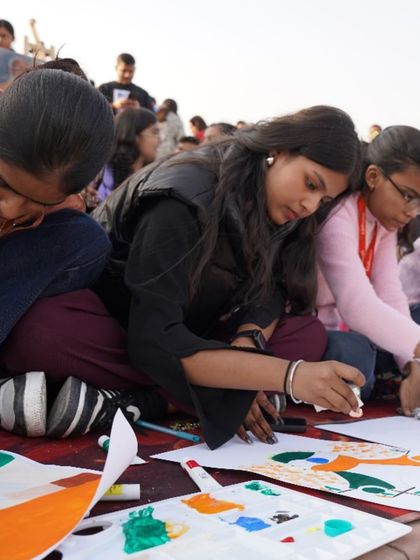 A close-up of students collaborating on their paintings. These events foster a sense of teamwork and shared purpose among our artists.