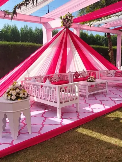 A beautiful outdoor Mehndi seating arrangement. I used a pink and white draped cabana with elegant white furniture to create a comfortable and stylish lounge area for guests.