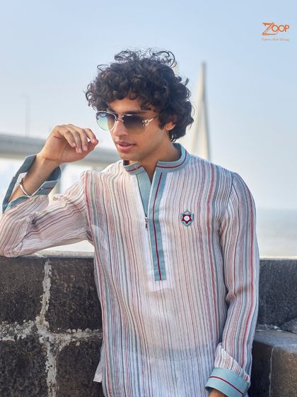 A soft-colored striped shirt that is a testament to understated luxury. The gentle hues and classic pattern make it a versatile piece for any wardrobe.