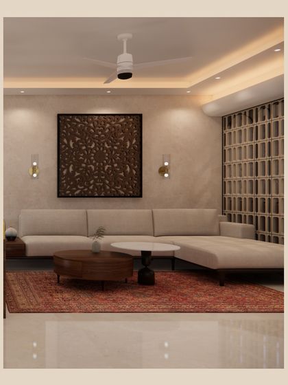Here, an L-shaped sofa provides ample seating, oriented towards a stunning carved wood art piece. The traditional red rug adds a layer of warmth and color, while the jali screen partition adds a touch of Indian heritage.