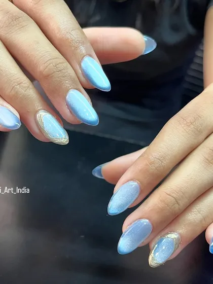 A cool blue cat eye polish with a touch of gold chrome on an accent nail. This is a beautiful and unique combination.