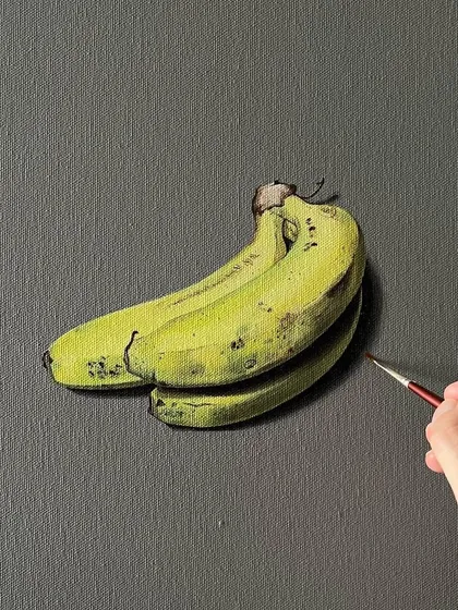 Another angle of my realistic banana painting. You can see the fine brushstrokes I used to create the texture and ripening spots on the peel.