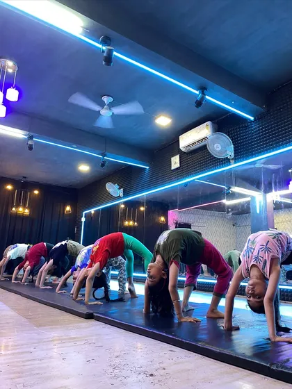 Our students work together on their backbends. Practicing in a group helps with motivation and allows our instructors to provide form corrections to the entire class.