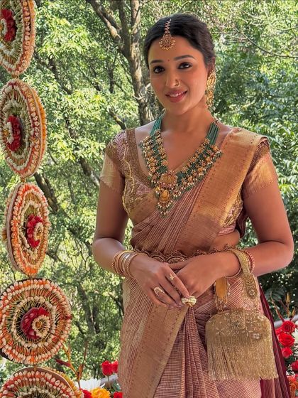 A beautiful shot of the bride in her traditional silk saree. My draping ensures the pleats are perfect and the pallu falls gracefully.