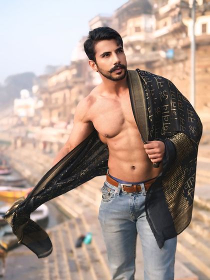 The fabric flows like the river behind, creating a dynamic and powerful portrait that captures the untamed energy of both the subject and the city.