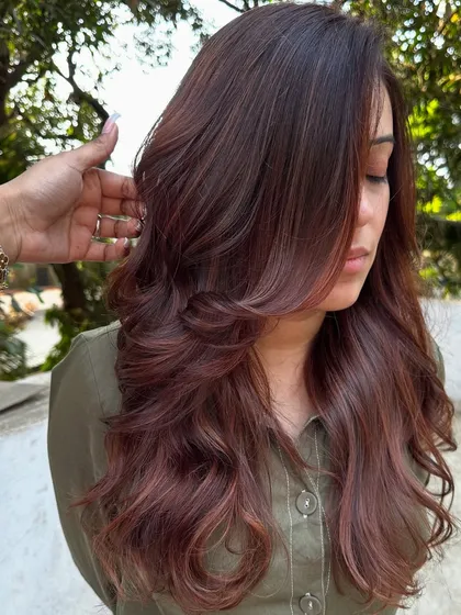 A 'Rose Gold' dream come true. We transformed her faded highlights into this stunning metallic pink shade. It’s a trendy yet sophisticated way to play with color.