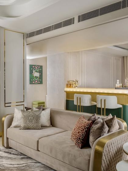 A seamless transition from the living area to the bar. The design uses architectural elements like a floating mirror and consistent color palettes to ensure different functional zones feel part of a cohesive whole.