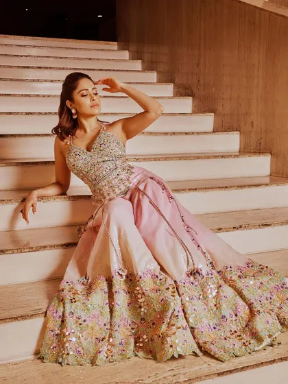 This pastel pink lehenga with intricate floral embroidery is a beautiful choice for a daytime event. I styled this look on Nushrratt Bharuccha for a soft, romantic, and elegant vibe.