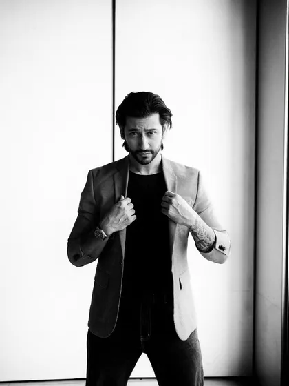 A strong, direct-to-camera black and white portrait. This kind of shot is perfect for an actor's headshot or a professional profile.
