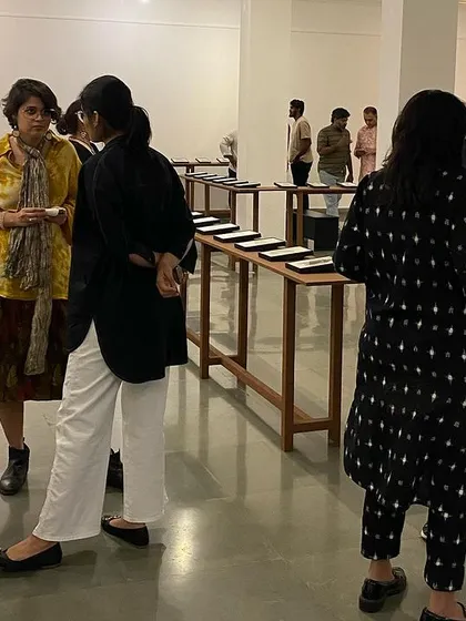 Guests gathered and discussing the works at the preview of 'Quieter than Silence'.