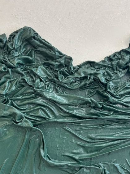 A close-up of a large 57" x 40" piece featuring a deep green cloth texture. The fabric is sculpted to look like a dramatic, mountainous landscape.