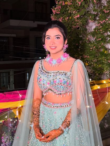 Surbhi, all smiles and ready for her Mehendi ceremony. The makeup is designed to last through all the fun and festivities.