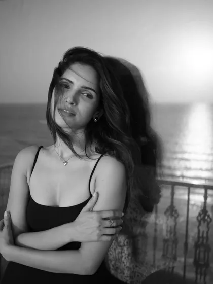 Captured on a balcony with the sea in the background. This unedited black and white photo has a beautiful, windswept feel, showcasing the power of a simple setup and natural environment.