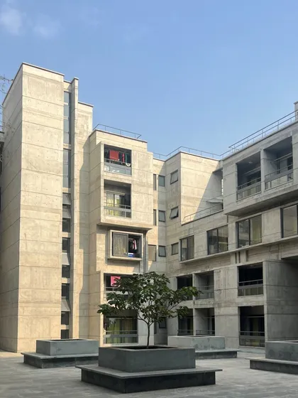 The central courtyard of the new IIM Bangalore hostel. This space was designed to accommodate existing trees and has become a hub of student activity, visually connected across all floors to foster a sense of community.