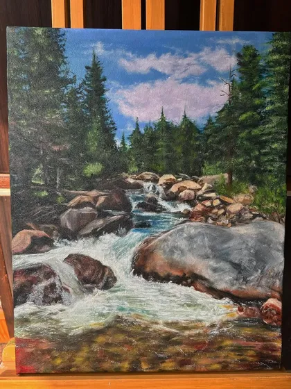 The full landscape painting on an easel. This piece is available for sale and would bring a sense of calm to any space.