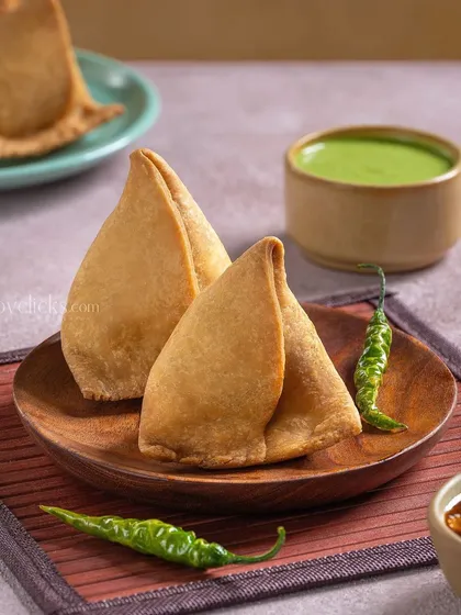 A classic Samosa from Gulab Sweets, served with green chutney and tamarind sauce.