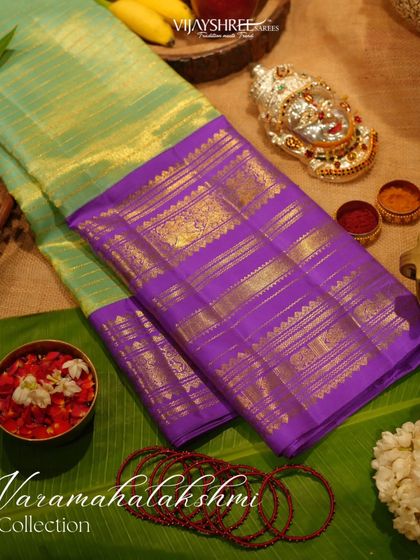 A vintage Kanjivaram tissue saree in light green and purple, a beautiful and unique choice for the Varamahalakshmi festival.
