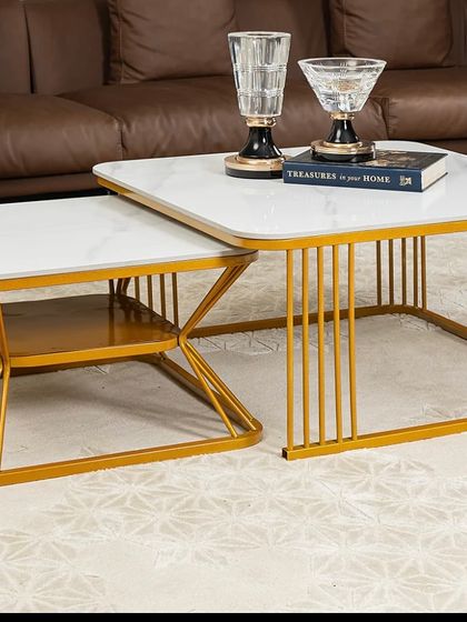 The same designer coffee table set, shown styled in a living room. This piece redefines sophistication with its sleek, modern design and practical nesting feature, making it a versatile center table for any home.